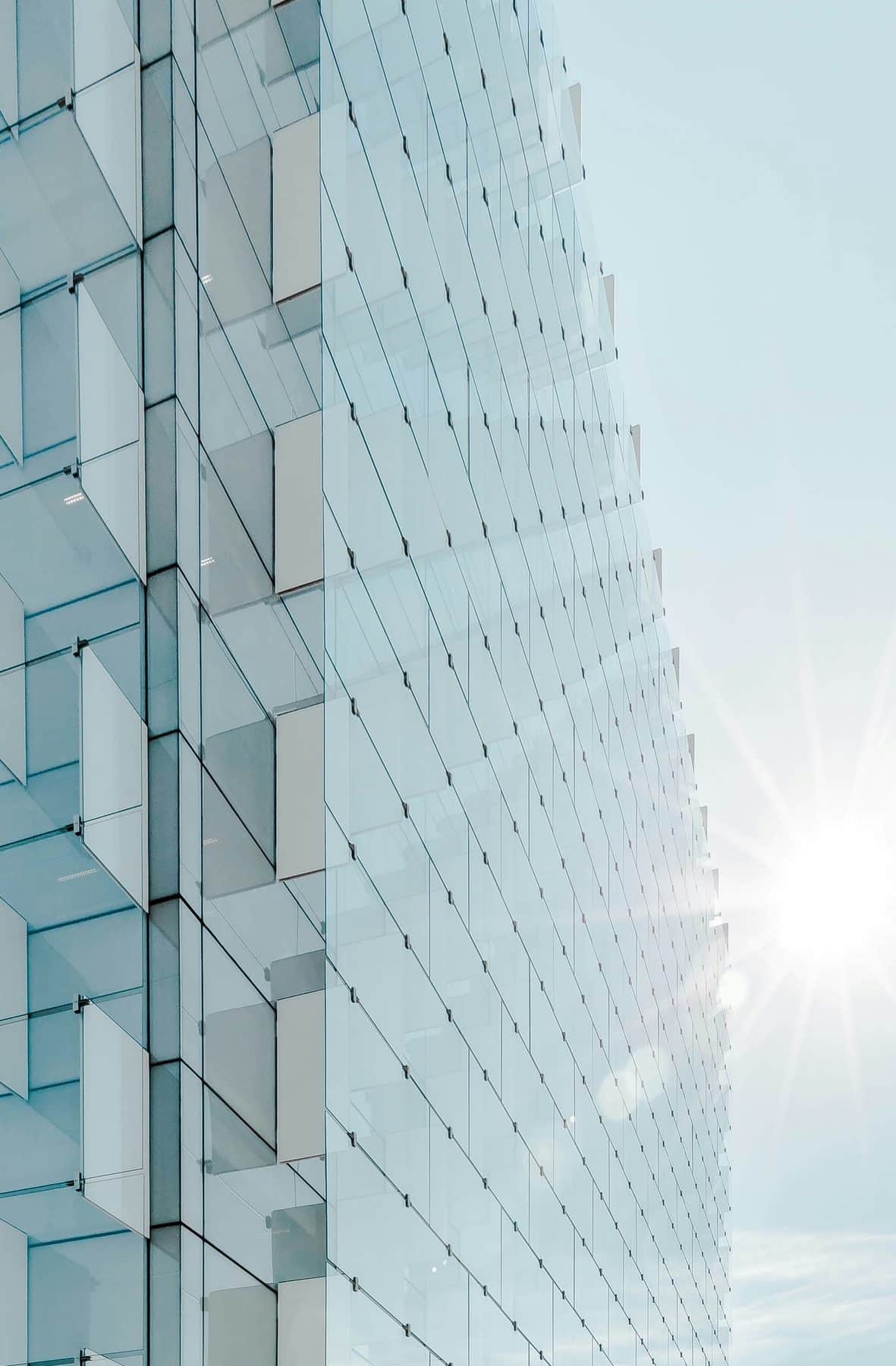 Sunlit glass curtain wall of a modern office tower