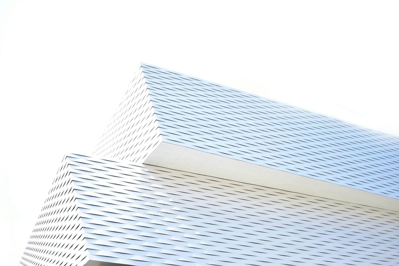 Abstract white architectural facade against a bright sky